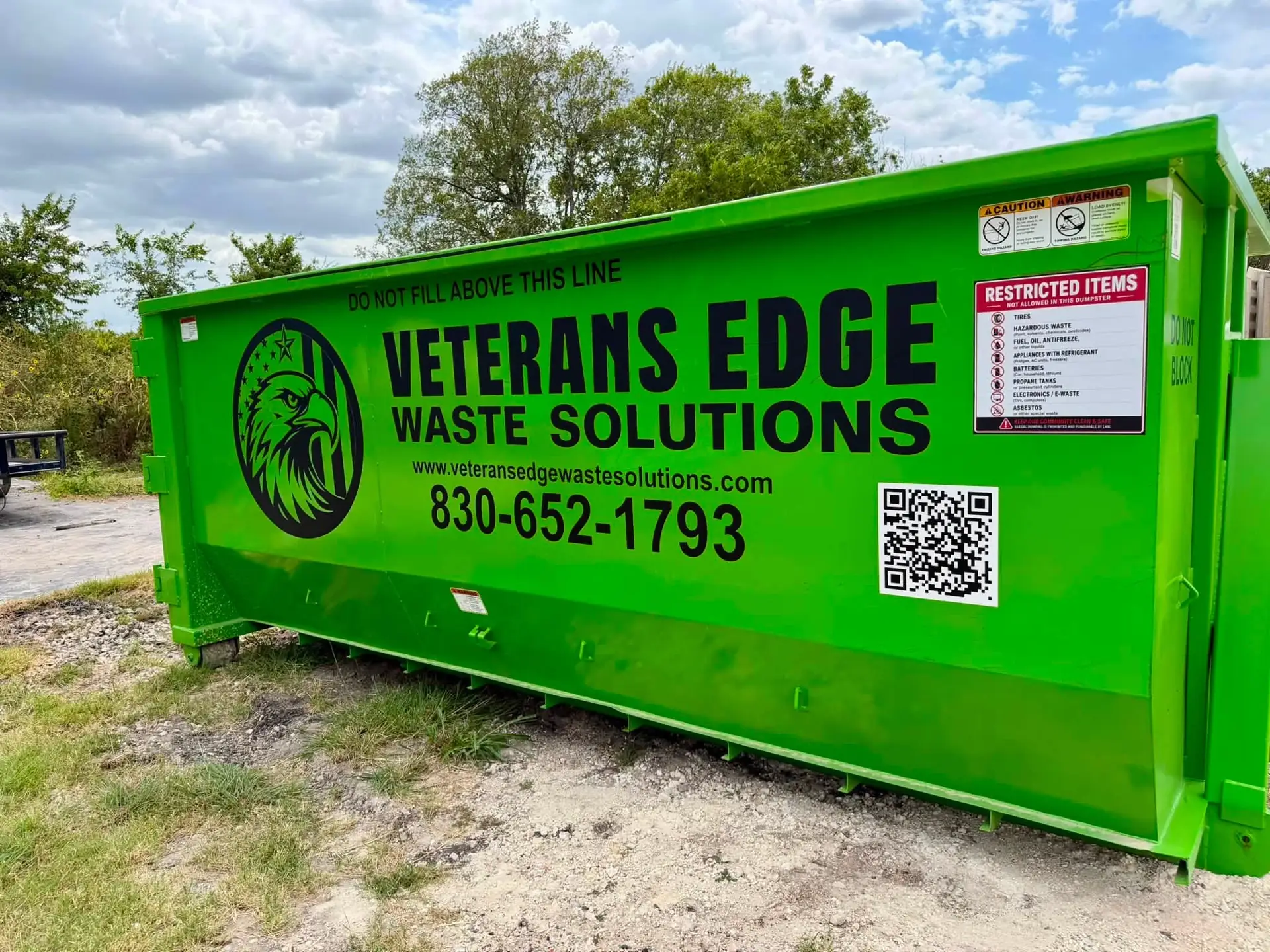 Veterans Edge Waste Solutions green roll-off dumpster